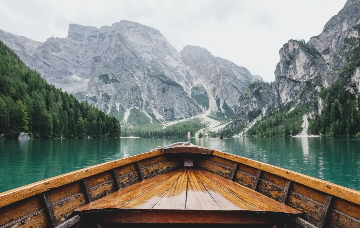 Serene landscape with rocky terrain and rolling hills under a cloudy sky, showcasing nature's beauty