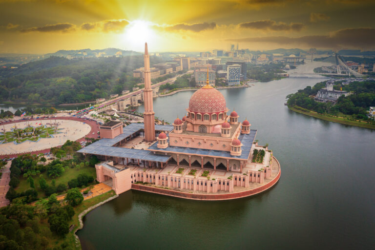 Aerial View Of Putra Mosque with Putrajaya City Centre with Lake at sunset in Putrajaya, Malaysia.