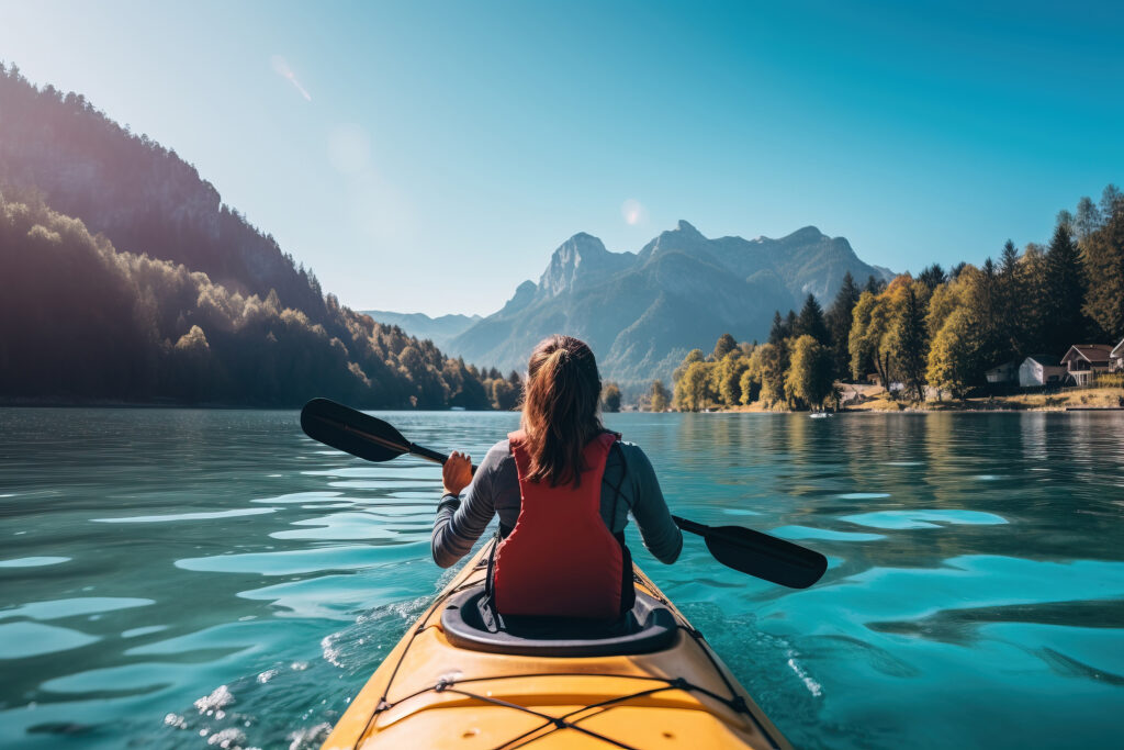 Back view of woman kayaking in crystal lake