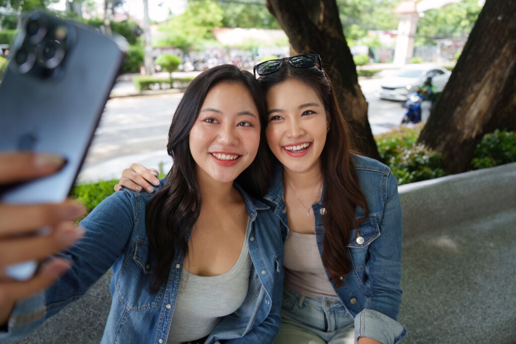 Connection and Laughter. Me and Harmony enjoying a smartphone pic together in a vibrant outdoor setting